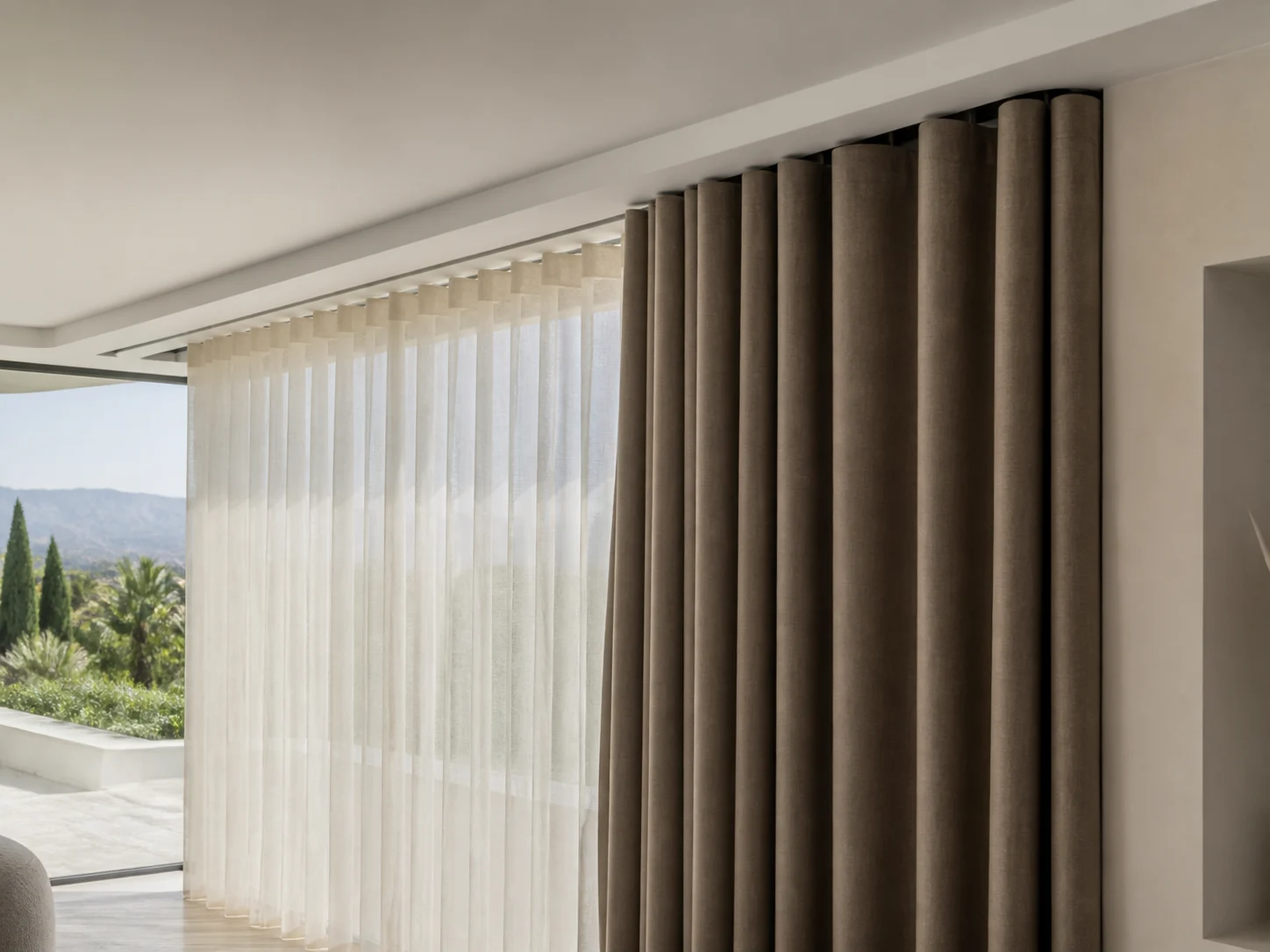 Dark blackout curtain layered in front of an ivory sheer on concealed double rails