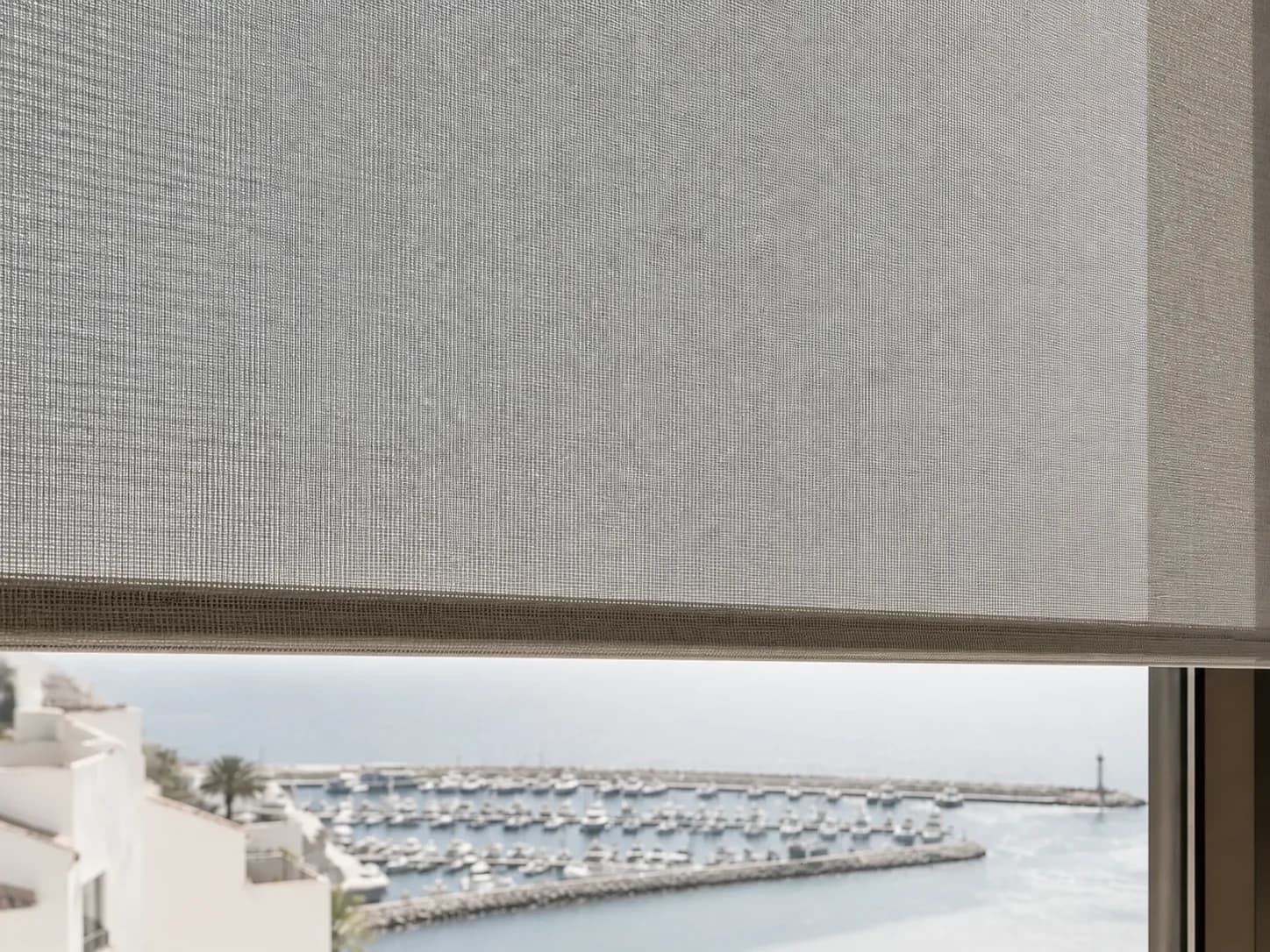 Technical solar-screen weave with the marina visible beyond